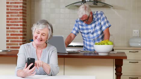 Senior-couple-on-laptop-and-phone
