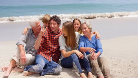 Multi-generation-family-sitting-on-the-beach
