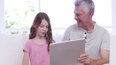 Grandfather-and-granddaughter-using-tablet