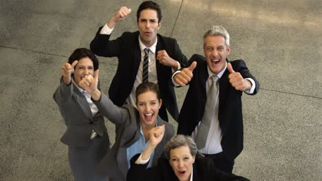 Business-people-cheering-with-thumbs-up