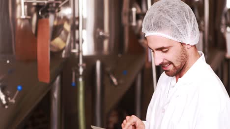 Smiling-brewery-worker-using-tablet