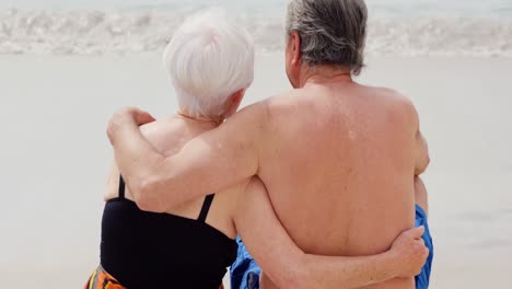 Retired-couple-hugging-on-a-surfboard