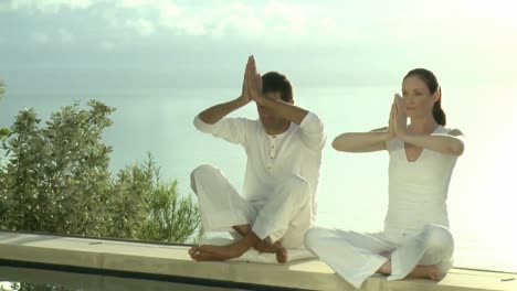 Two-Persons-doing-Yoga-with-Sea-in-the-Background