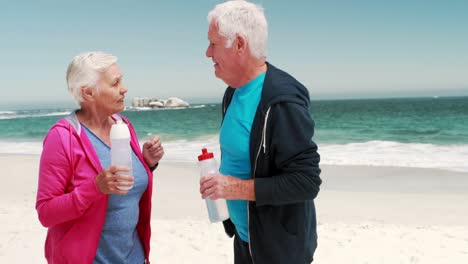 Old-retired-couple-drinking-water-after-sport
