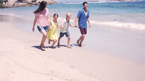 Family-running-on-the-beach