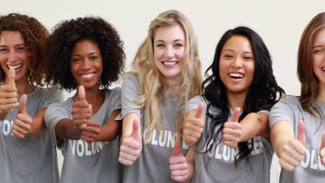 Happy-female-volunteers-showing-thumbs-up