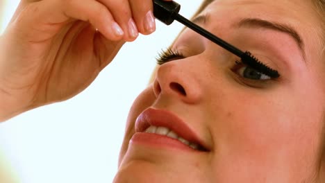 -Close-up-of-a-beautiful-young-woman-applying-mascara-