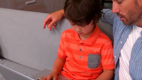 Father-and-son-using-laptop