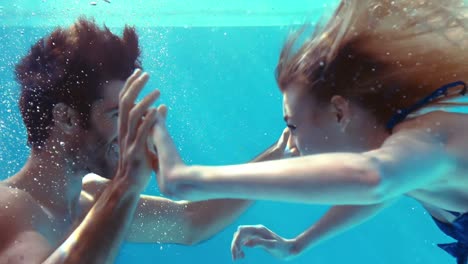 Happy-couple-cheering-underwater
