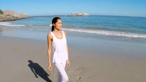 Young-woman-walking-on-beach