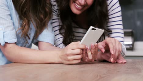 Two-female-friends-watching-smartphone