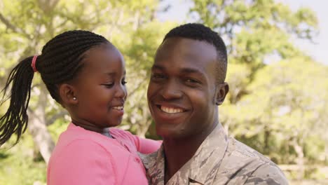 American-soldier-is-embracing-his-daughter-