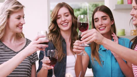 Happy-friends-toasting-with-red-wine
