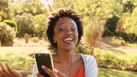Portrait-of-woman-is-looking-a-smartphone-and-laughing-