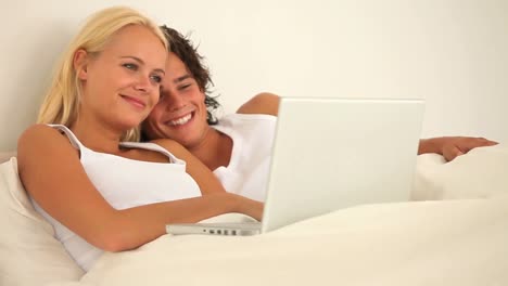 Cheerful-lovely-couple-with-a-laptop-