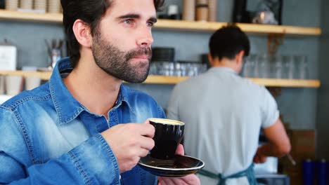 Portrait-of-young-hipster-is-drinking-a-coffee