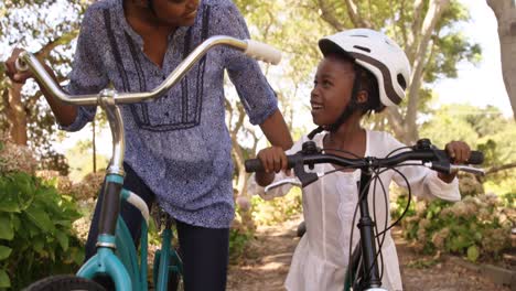 Mother-and-daughter-are-preparing-to-riding-bike-