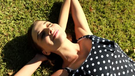 Woman-lying-on-grass-in-park