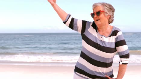 an-elderly-woman-standing-on-the-beach