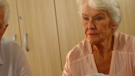 Thoughtful-senior-woman-with-a-cup-of-coffee