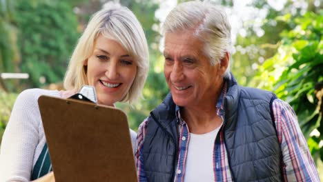 Mature-couple-looking-at-clipboard