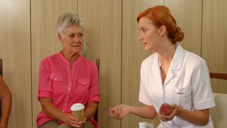 Therapist-talking-to-two-senior-women