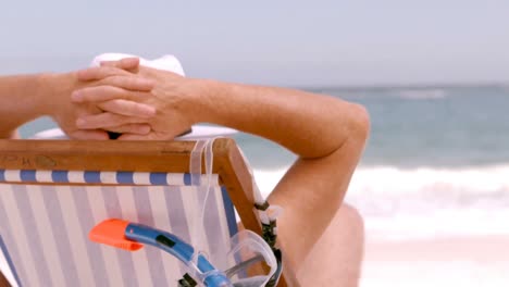 an-elderly-man-sitting-in-the-beach-chair-