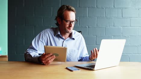 Businessman-interacting-with-client-over-video-calling-on-laptop