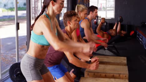 Group-of-people-performing-plyometrics-exercise