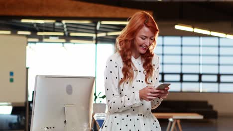 Businesswoman-text-messaging-on-mobile-phone