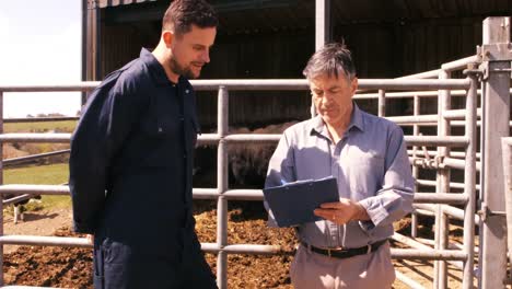 Cattle-farmer-interacting-with-a-man-on-clipboard