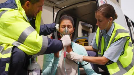 Patient-receiving-oxygen-mask-from-ambulance-team-