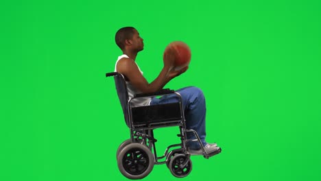 Ethnic-boy-on-a-wheelchair-playing-with-a-basket-ball