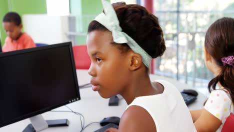 Schoolgirls-using-computer-in-classroom