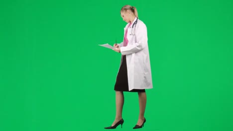 Female-doctor-writing-notes-against-green-screen