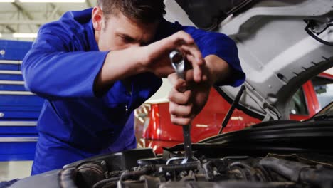 Male-mechanic-servicing-a-car