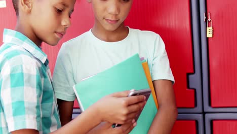 Schoolkids-using-mobile-phone-in-school
