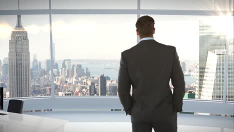 Businessman-standing-and-looking-at-office-window