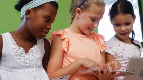 Schoolgirls-using-digital-tablet