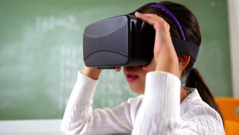 Schoolgirl-using-virtual-reality-glasses-in-classroom