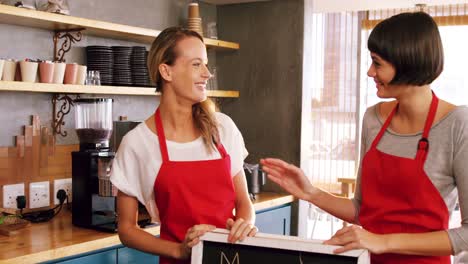 Smiling-waitress-standing-with-menu-board