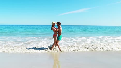 Man-lifting-woman-at-beach