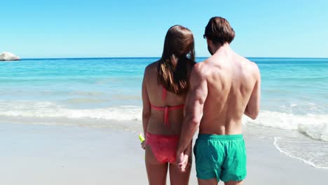 Couple-walking-on-beach