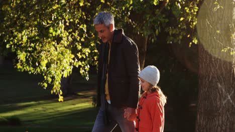 Girl-walking-with-dad-outdoors