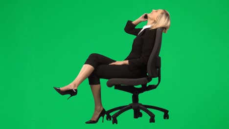 Businesswoman-sitting-on-a-chair-on-phone-against-green-screen-footage