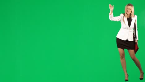 Businesswoman-calling-a-taxi-against-green-screen