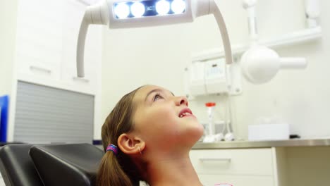 Young-patient-sitting-on-dentists-chair