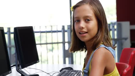 Schoolgirl-using-computer-in-classroom