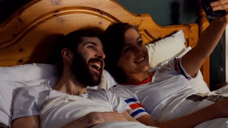Couple-taking-selfie-from-mobile-phone-in-bedroom