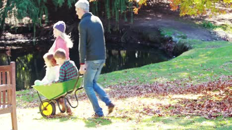 Parents-carrying-their-son-and-daughter-in-a-wheelbarrow